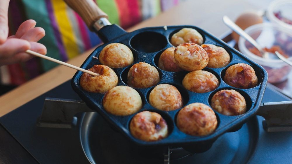 takoyaki being cooked on the grill